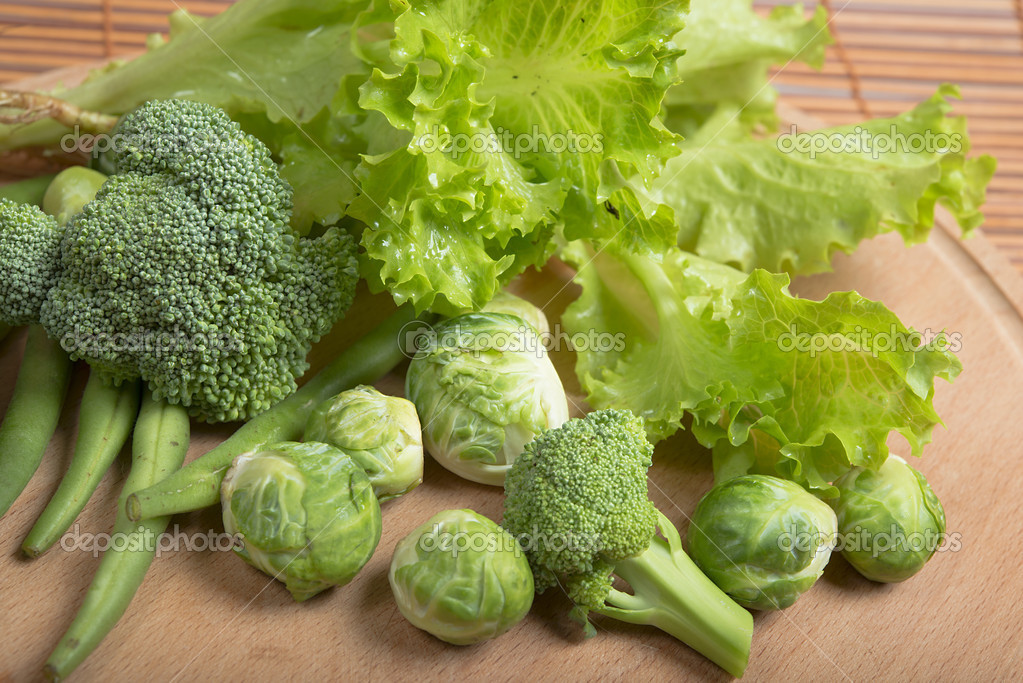 Fresh raw asparagus beans, brussels sprouts, broccoli and lettuce on