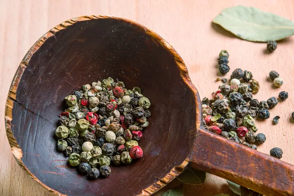 Vintage wood spoon with spices and  bay leaves — Stock Photo, Image