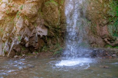 Beautiful waterfall on the mountain. Waterfall in the mountains of the North Caucasus.