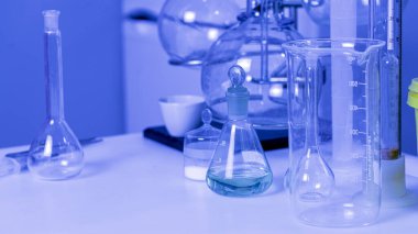 Chemical test tube close up on blue background.