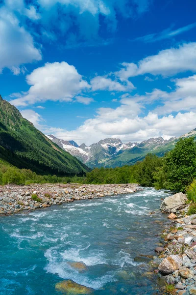 View of the mountain river in the gorge, North Ossetia, Russia. Impenetrable rocks, majestic sun, mountains and forests.