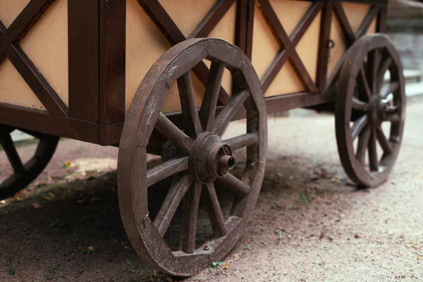 Old round wheels on a mobile wooden cart — Stock Photo, Image