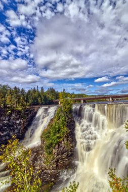 The main and the side falls frozen in time under the bright morning sky - Kakabeka Falls, Thunder Bay, ON, Canada