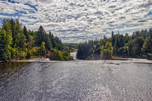 Bright sun shining on the water before the descent - Kakabeka Falls, Thunder Bay, ON, Canada