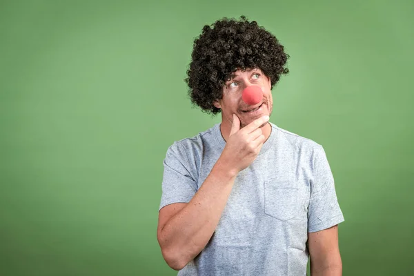 Man Black Wig Red Clown Nose Posing Front Green Background — Stock Photo, Image
