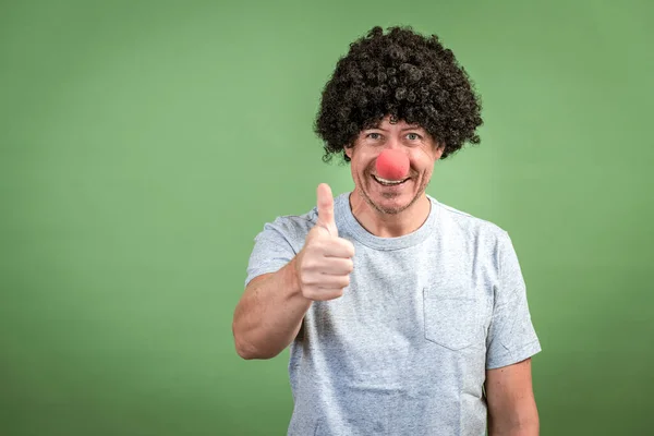 Man Black Wig Red Clown Nose Posing Front Green Background — Stock Photo, Image