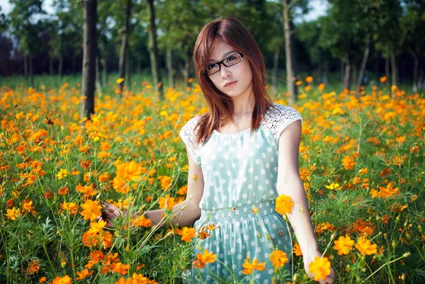 Young girl in a flower field — Stock Photo, Image