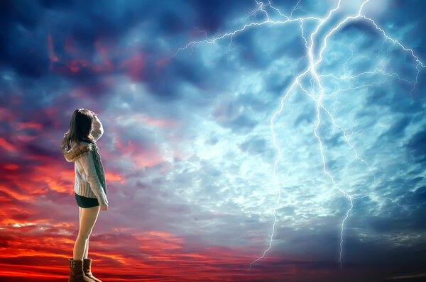 Girl looked at the lightning in the sky