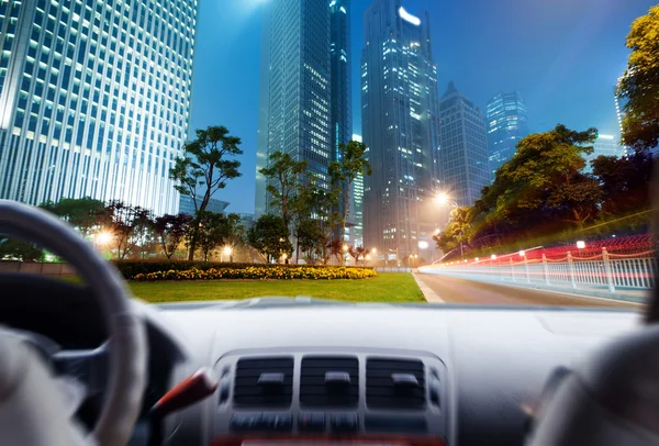 Las manos del conductor en un volante de un coche y escena nocturna — Foto de Stock