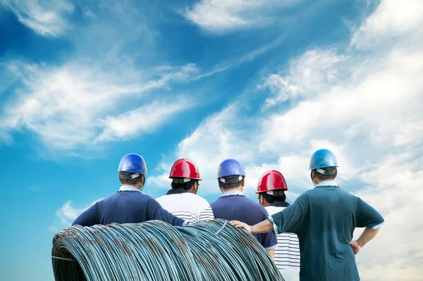 Back of workers with blue sky — Stock Photo, Image