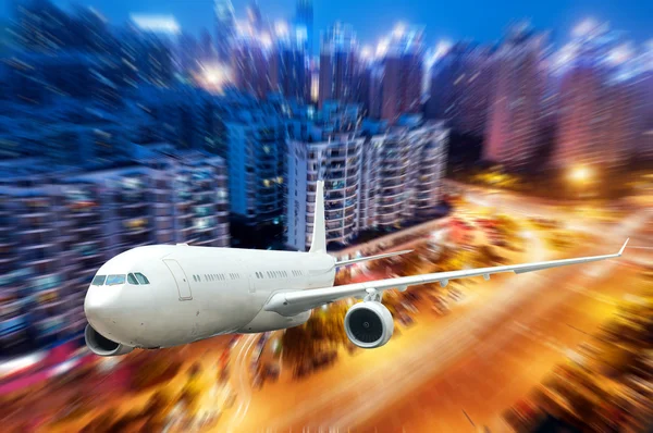 The airplane away from the city — Stock Photo, Image