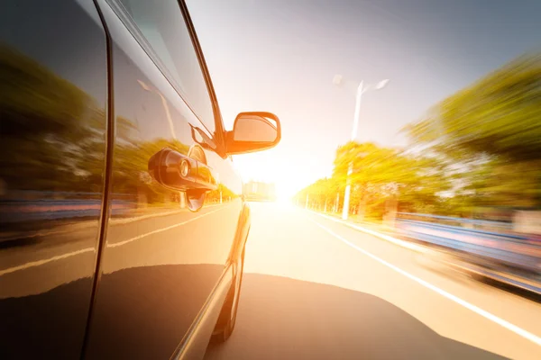 Um carro a conduzir numa auto-estrada a altas velocidades — Fotografia de Stock