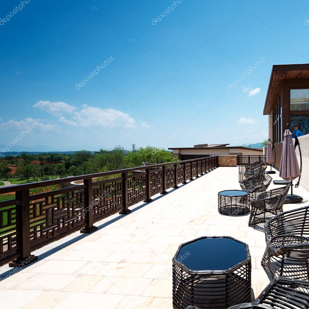 Armchairs and a table on an open terrace