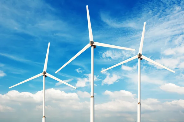 Green renewable energy concept - wind generator turbines in sky Royalty Free Stock Photos