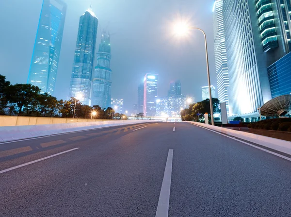 Asphalt road and modern city — Stock Photo, Image