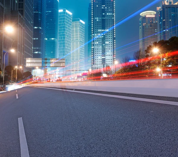 Asphalt road and modern city — Stock Photo, Image