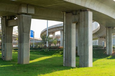 Şehirdeki üst geçidin altında beton yapı ve asfalt yol alanı