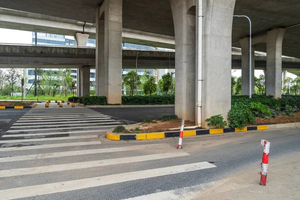 Concrete structure and asphalt road space under the overpass in the city