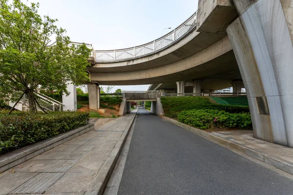 Concrete structure and asphalt road space under the overpass in the city