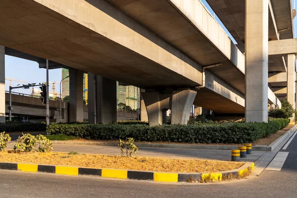 Concrete structure and asphalt road space under the overpass in the city