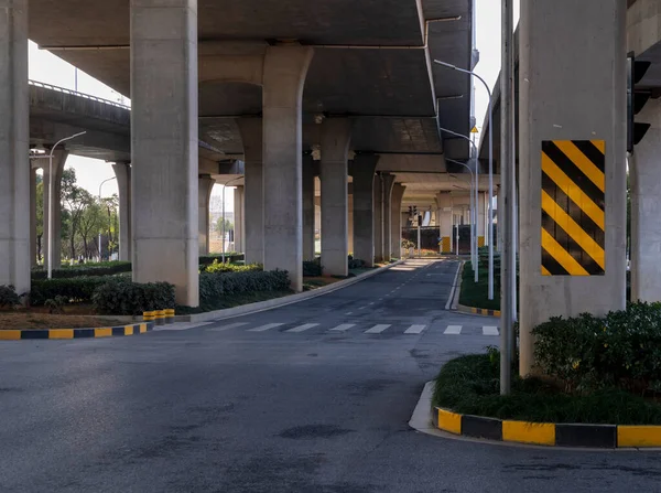 Concrete structure and asphalt road space under the overpass in the city