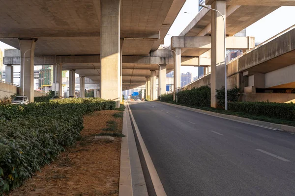 Concrete structure and asphalt road space under the overpass in the city