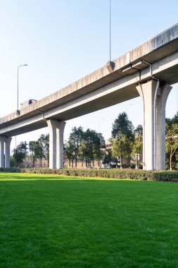 Şehirdeki üst geçidin altında beton yapı ve asfalt yol alanı