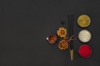 Conceptual pooja background with  rice, kumkum and flowers