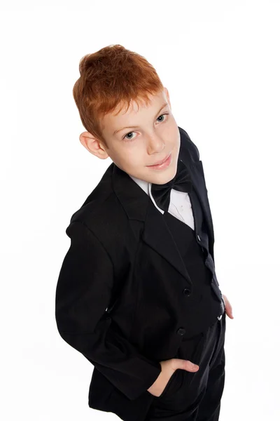 Вoy with red hair in a black suit with bow tie — Stock Photo, Image