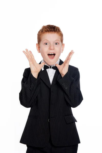 Вoy with red hair in a black suit with bow tie — Stock Photo, Image