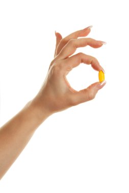 beyaz zemin üzerinde bir hap ile el