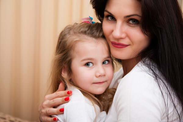 Portrait of young mother and her small daughter.