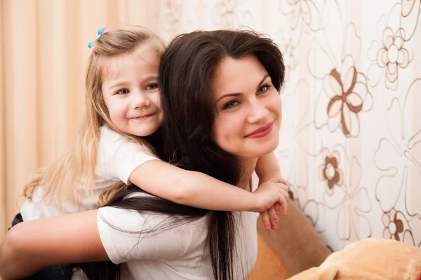 Portrait of young mother and her small daughter. — Stock Photo, Image