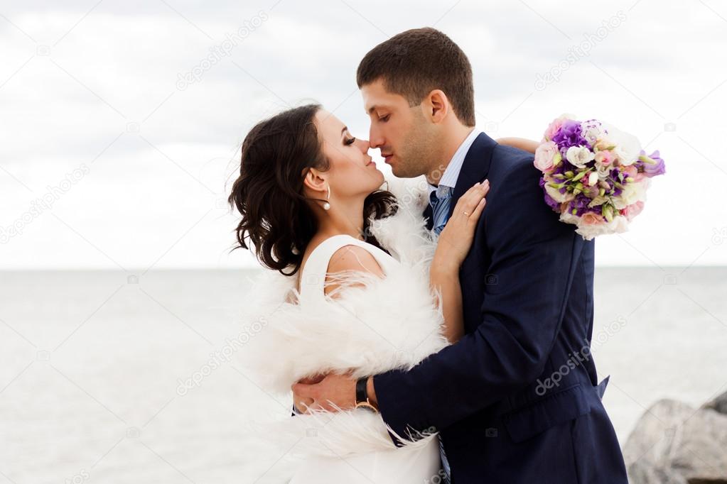 Loving bride and groom near the sea
