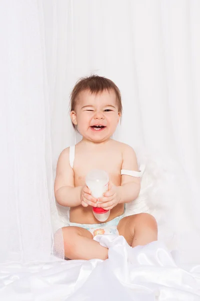 Laughing baby with angel wings sitting — Stock Photo, Image