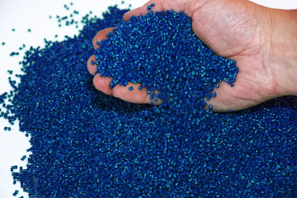 Hands checking blue polymer resin Stock Picture