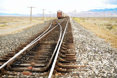 Approaching freight train on tracks, NW Nevada, US clipart