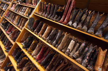 Cowboy boots line the shelves, Austin, Texas, US clipart