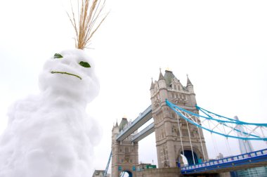 Snowman in front of Tower Bridge, London, UK clipart