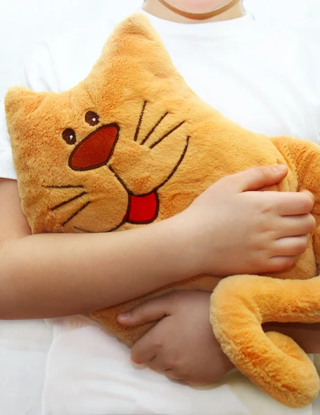 Little girl hugging toy cat