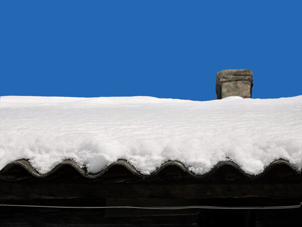 snow on a roof of the old house