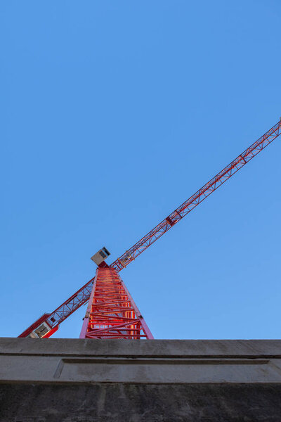 A large crane is on a construction site on a sunny day