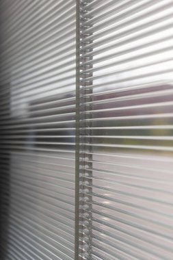 In a modern building, this window is incorporated with a venetian blind