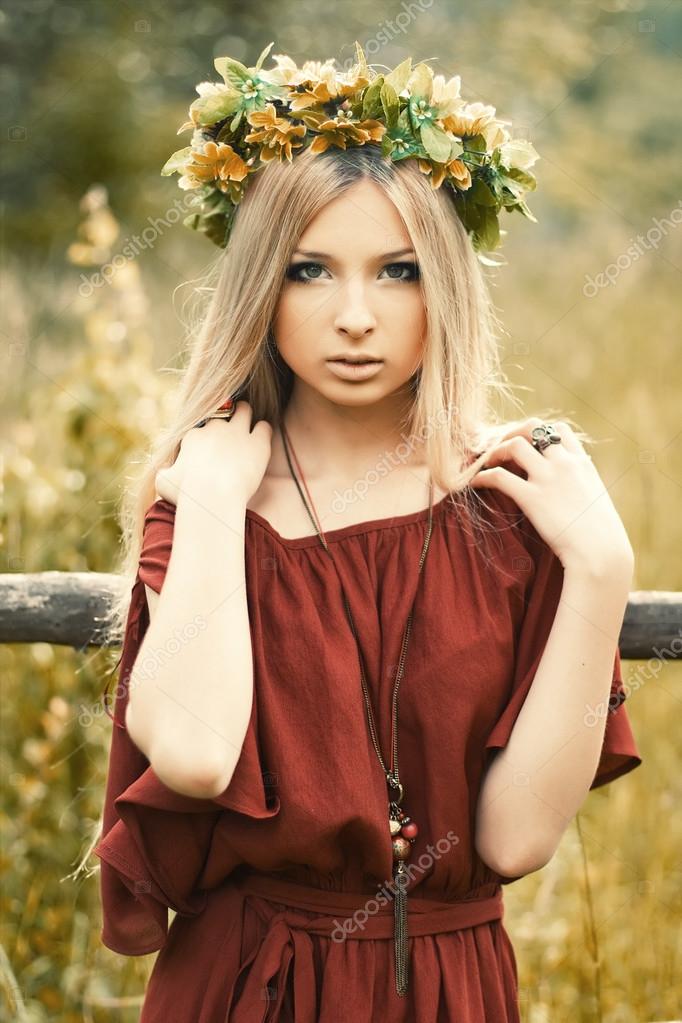 Girl with flowers on her head — Stock Photo © SolominViktor 23096890