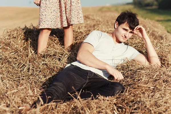 Young boy lying in hay. — Stock Photo, Image