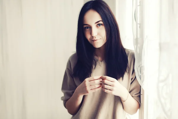 Young pretty woman near the window. — Stock Photo, Image