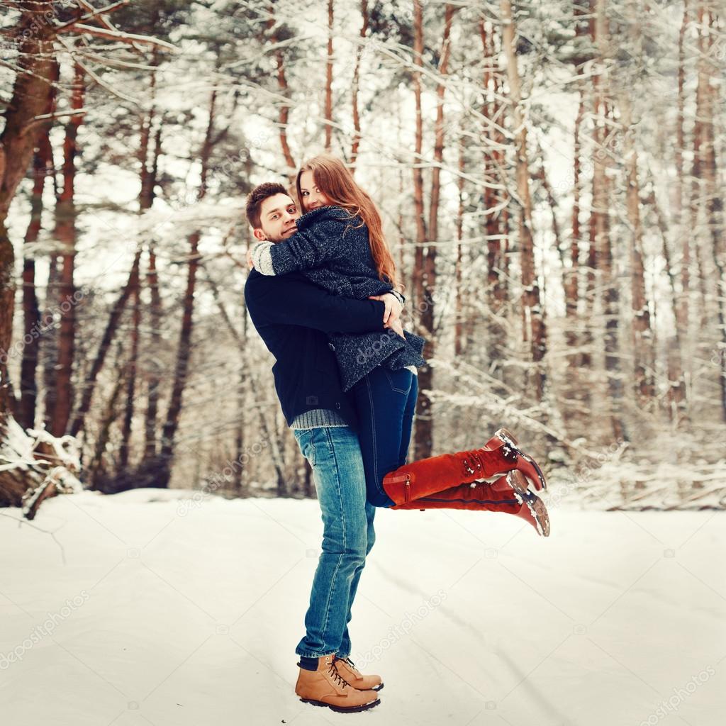 Young couple having fun outdoor in winter