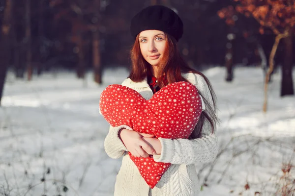 Girl in park with big red heart. — Stock Photo, Image