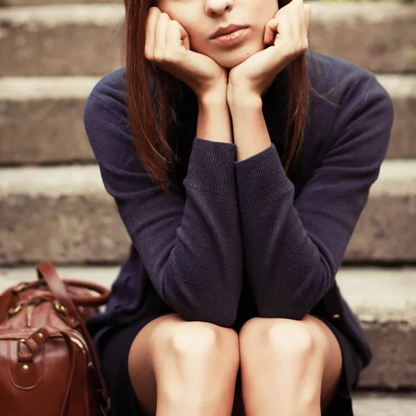 Girl sitting on the stairs alone — Stock Photo, Image