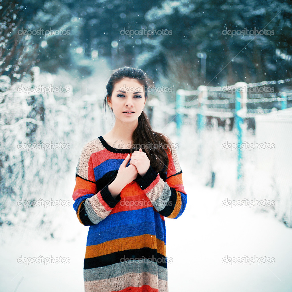 Beautiful brunette in winter park.